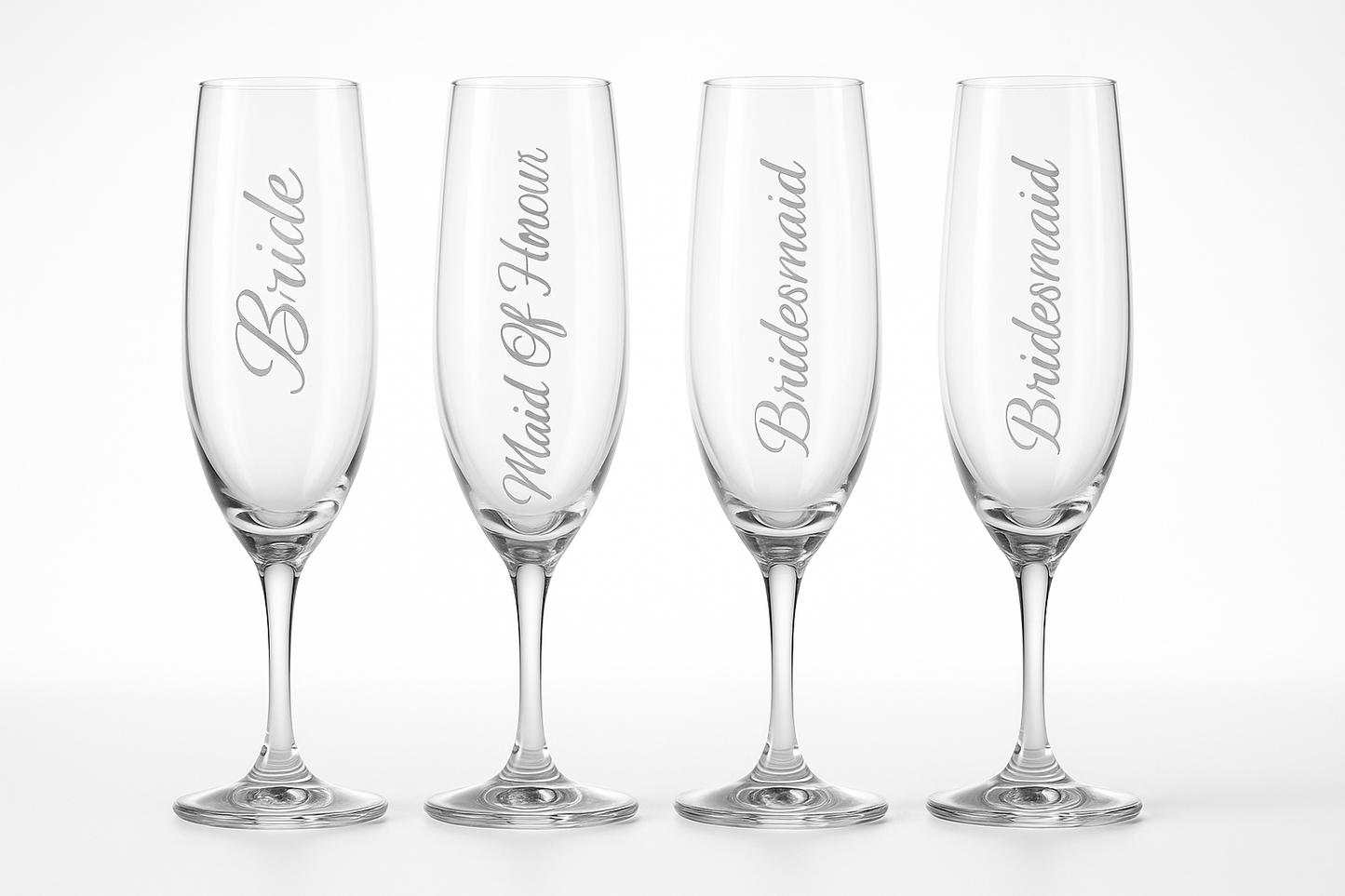 Four elegant champagne flutes with wedding party titles etched vertically down the sides