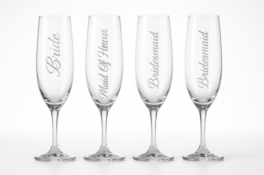 Four elegant champagne flutes with wedding party titles etched vertically down the sides